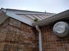A weed grows out of the muck in the gutter. The wood facia board stays moist. Roof rot, hello! Several houses in the community have the same look. The property manager ought to warn them: This here problem unrepaired still, 9/27/2021.