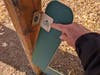 With a large pliers in hand, you could unfasten bolts and remove these broken parts from the playground. This wouldn't be a total repair, but perhaps the worst hazard (loose stuff) would be eliminated. A brief, common-sense job for a handyman with pliers.