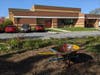 The garden was on the far side of a utility driveway used by repair trucks and garbage trucks to access the loading dock and dumpsters. It’s “across the driveway” from the school. It’s a space not used by students, teachers, or staff during school hours. 