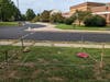 The garden would be ACROSS from a utility drive, meaning that students could not casually walk into it during school hours. Yellow tape shows where a crosswalk will be painted. Students cross the drive on their way to school at that point.