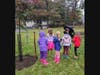 The children (several from a Girl Scout troop) practiced spreading mulch around each sapling while keeping the mulch 2 inches AWAY from the trunk. The mulch ring should not touch the trunk, but should have a doughnut shape. 