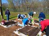Church volunteers and residents help install the gardens.
