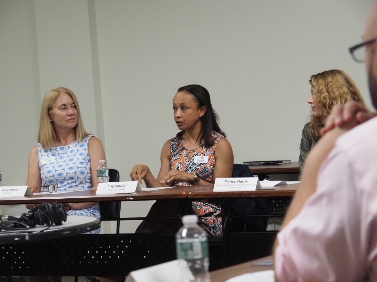 New Hampshire Food Bank Executive Director Elsy Cipriani (center) speaks about her concerns that recent state policy changes will harm the state’s already low SNAP enrollment rates. 