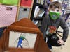 Logan Paccione presents one of his illustrations in the Kamishibai box at Seaford Harbor Elementary School. 