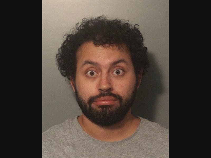 A Bellmore man was taken into custody after throwing bottles at cars and attacking an officer Wednesday, police said. 