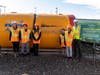 Students from the Fulton Avenue Elementary School flank the boring machine named "Marsh-Mellow." 