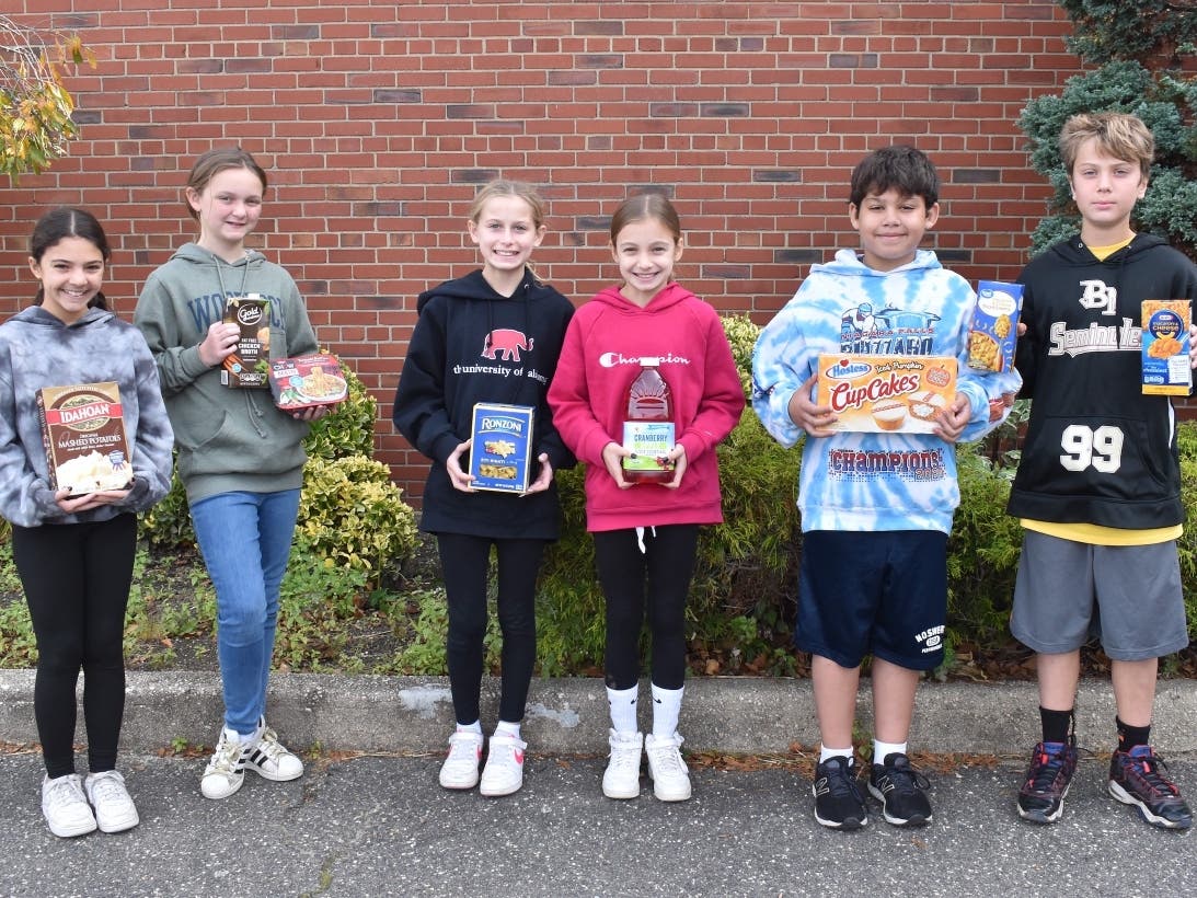 Sixth graders at Newbridge Road Elementary assist in a neighborhood food drive. 