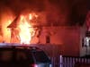 Flames pour out of a home on Herkimer Street on Saturday night. 