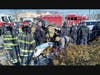 Firefighters rescue the victim of a car crash in Merrick on Thursday morning, police say. 