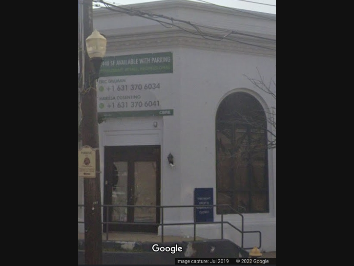 Residents stand in opposition to a realtor's plan to build a four-story apartment building in a business district. 