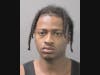 Marvens Chery was arrested after a loaded handgun was found at his Elmont residence, police say. 