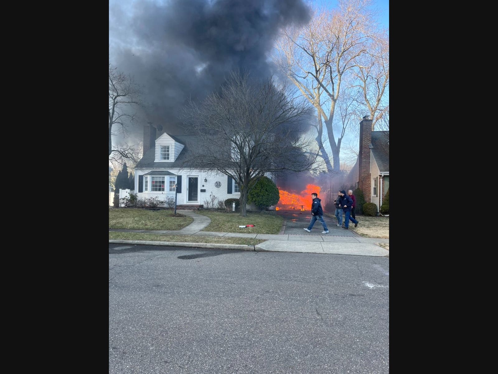 Flames could be seen coming from a detached garage in North Merrick on Wednesday. 