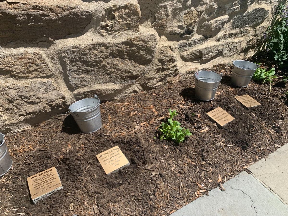 Memorial Stones honoring four enslaved people who lived in Greenwich were placed at the Historical Society during a ceremony on Thursday.