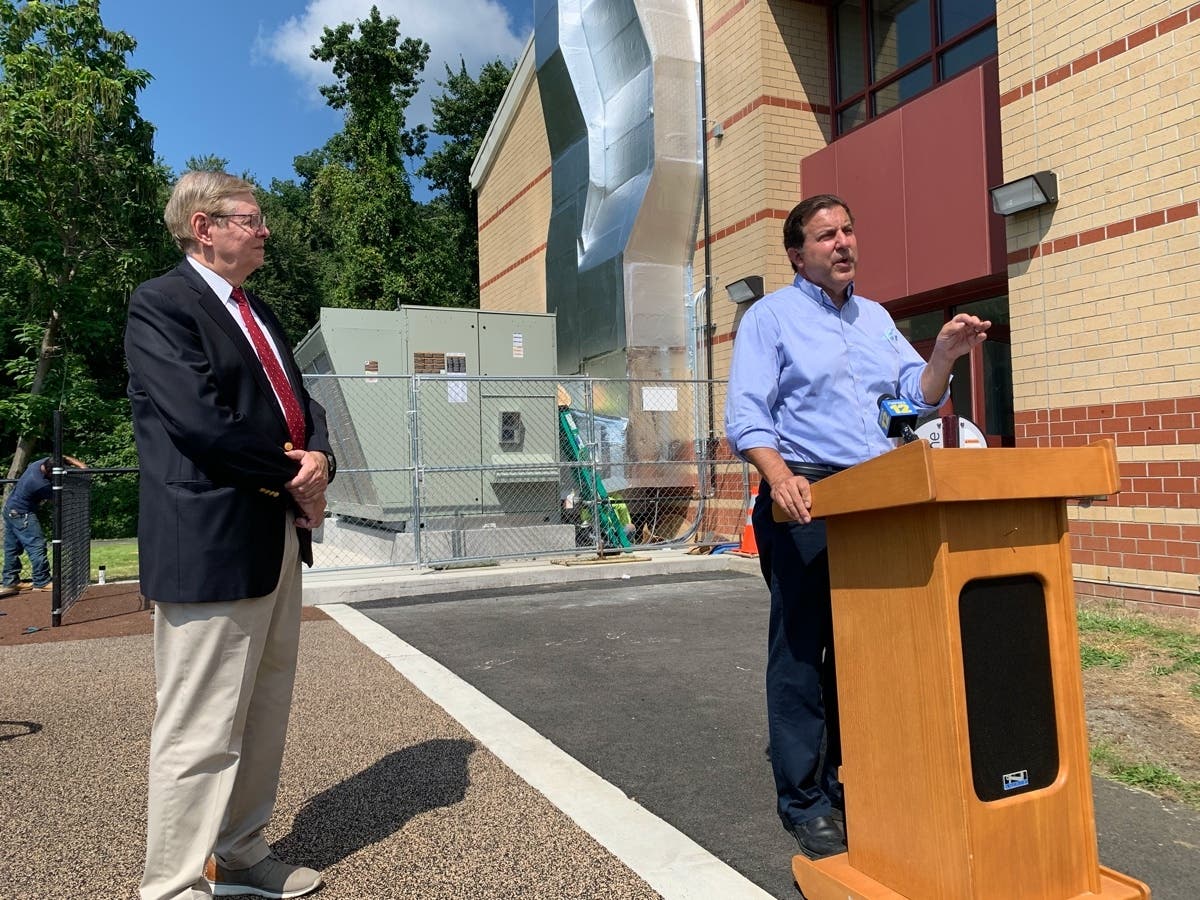 Mayor David Martin and city engineer Lou Casolo unveiled the new Dedicated Outdoor Air Systems, which can be seen behind them, at Westover Elementary School on Friday.
