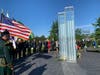 Attendees placed roses at the base of the 9/11 memorial in Cos Cob Park. The memorial holds the names of those in Greenwich who were lost in the attacks.