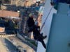 Biran Cashman (gray knit cap) practiced rappelling from the Landmark Building in downtown Stamford Friday morning. The annual Heights & Lights Rappelling Santa event will take place Sunday, Dec. 5.