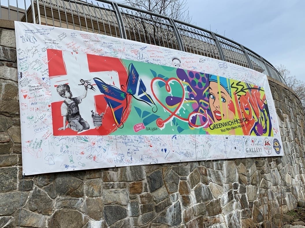 A large mural, sponsored by Greenwich's C. Parker Gallery and created by artist Rick Garcia, was dedicated during an event in the Bennett Community Garden at Greenwich Hospital on Monday.