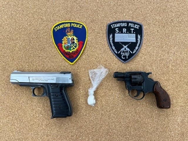 Police said Thursday they seized two guns, 2.5 grams of crack cocaine and ammunition from an apartment on Perry Street.