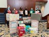 Albert Calixto (third from right) of Neighbor to Neighbor in Greenwich, accepts a donation of diapers from Greenwich Hospital’s Marc Kosak, Diana O’Marra, Annie Nardi, Andres Yanez and Martha Judd.
