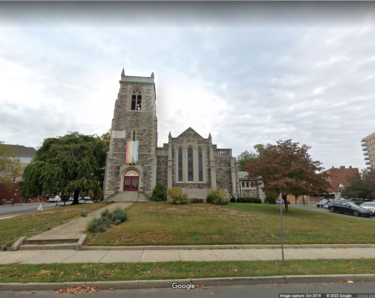 The apartment building would serve as a backdrop to the stone church.
