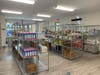 The food pantry features shopping carts, a refrigerated section, aisles of shelves, with canned goods and a fresh produce section.