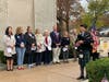 Greenwich's elected officials look on as William E. Hong of the Greenwich Pipe Band plays "Amazing Grace."