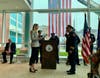 Mayor Caroline Simmons administers the oath to new Asst. Police Chief Richard Conklin during a swearing-in ceremony on Wednesday, Dec. 8, 2022.