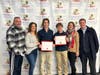 Nicholas Barone (center, left) and Garin Kopilak (center, right) with their families after receiving their scholarship awards this week.