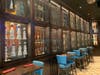A giant wall featuring an array of tequilas separates the bar area from the main dining room.