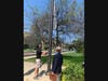 Gregg Pauletti raises the Childhood Cancer Awareness Month flag at Greenwich Town Hall as First Selectman Fred Camillo looks on.