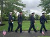 Greenwich first responders walk the winding path up to the 9/11 memorial in Cos Cob Park.