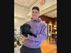 A noted dog lover who has two Dachshunds, Aaron Judge posed for a picture with a service dog puppy that was at Coffee For Good.