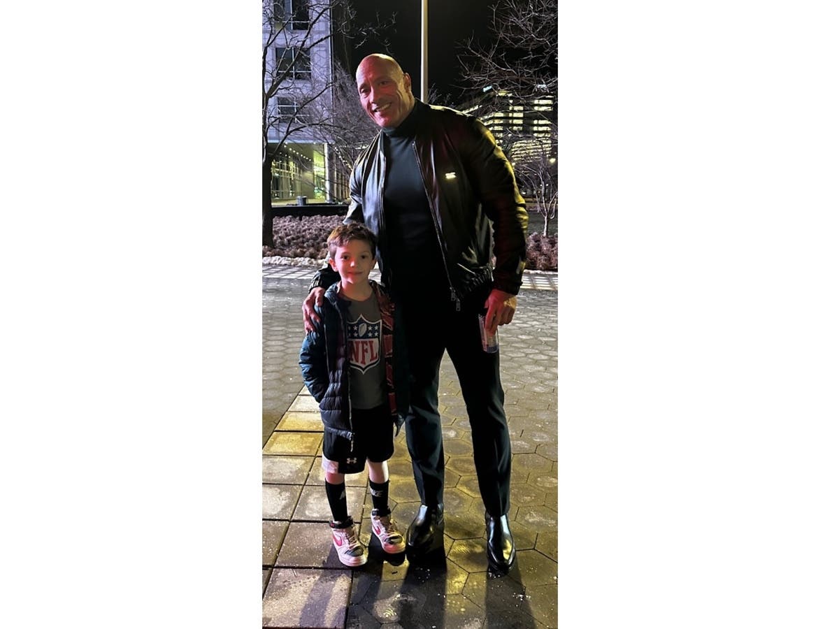 Blake Smith, 7, of Stamford, posing with actor and WWE superstar Dwayne "The Rock" Johnson on Tuesday, Jan. 23, outside of WWE Headquarters in Stamford.