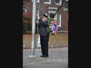 Greenwich Police Chief Jim Heavey raises the flag.