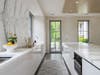 The open floor plan is anchored by a sleek kitchen.