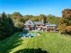 The property features a full outdoor kitchen, heated pool and dedicated basketball area.
