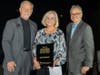 Morris Myers (Emcee, L) and Adam Eventov (Emcee, R) post with Wildomar Volunteer of the Year, Deb Robinet.