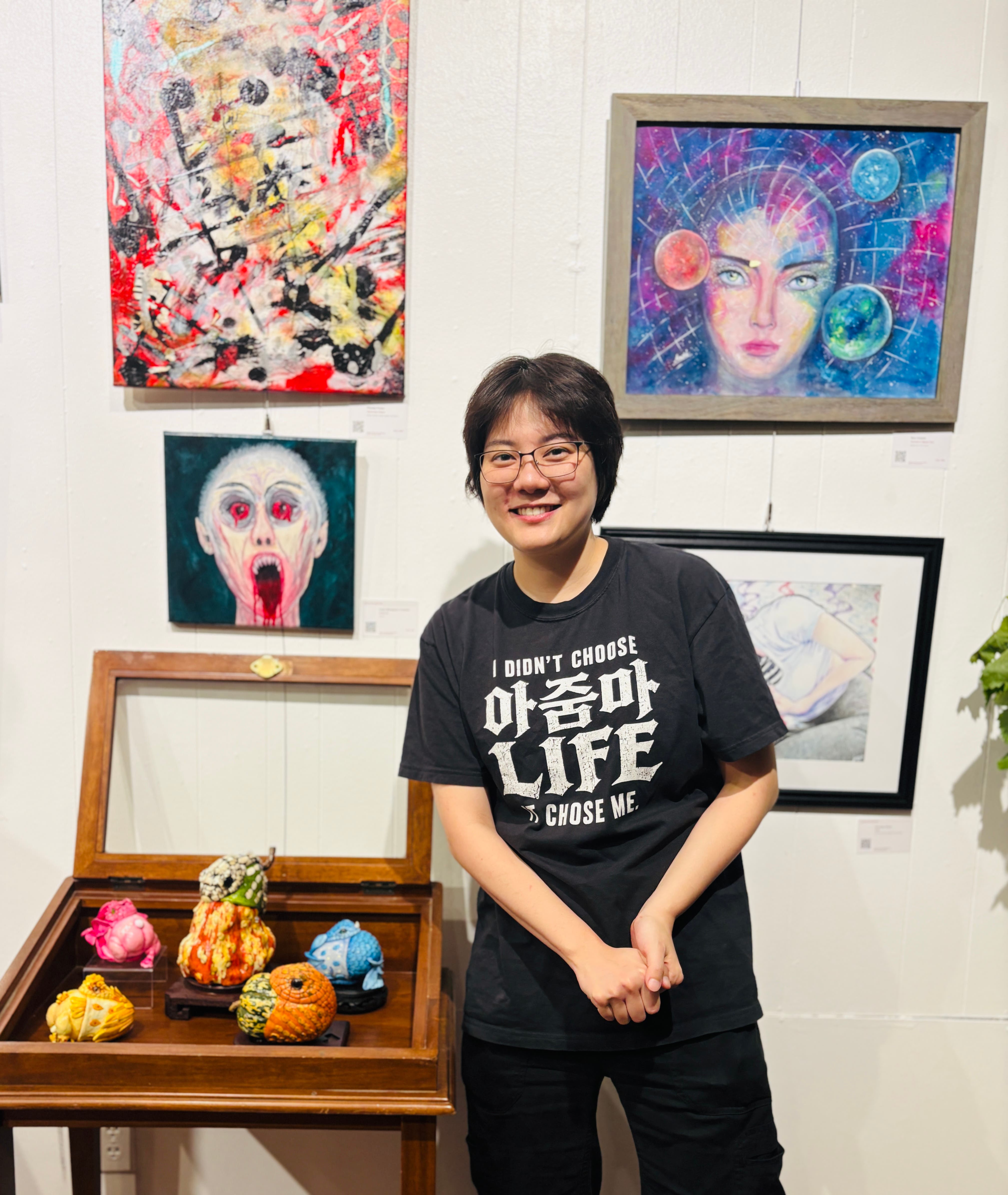 Woman in front of art exhibition