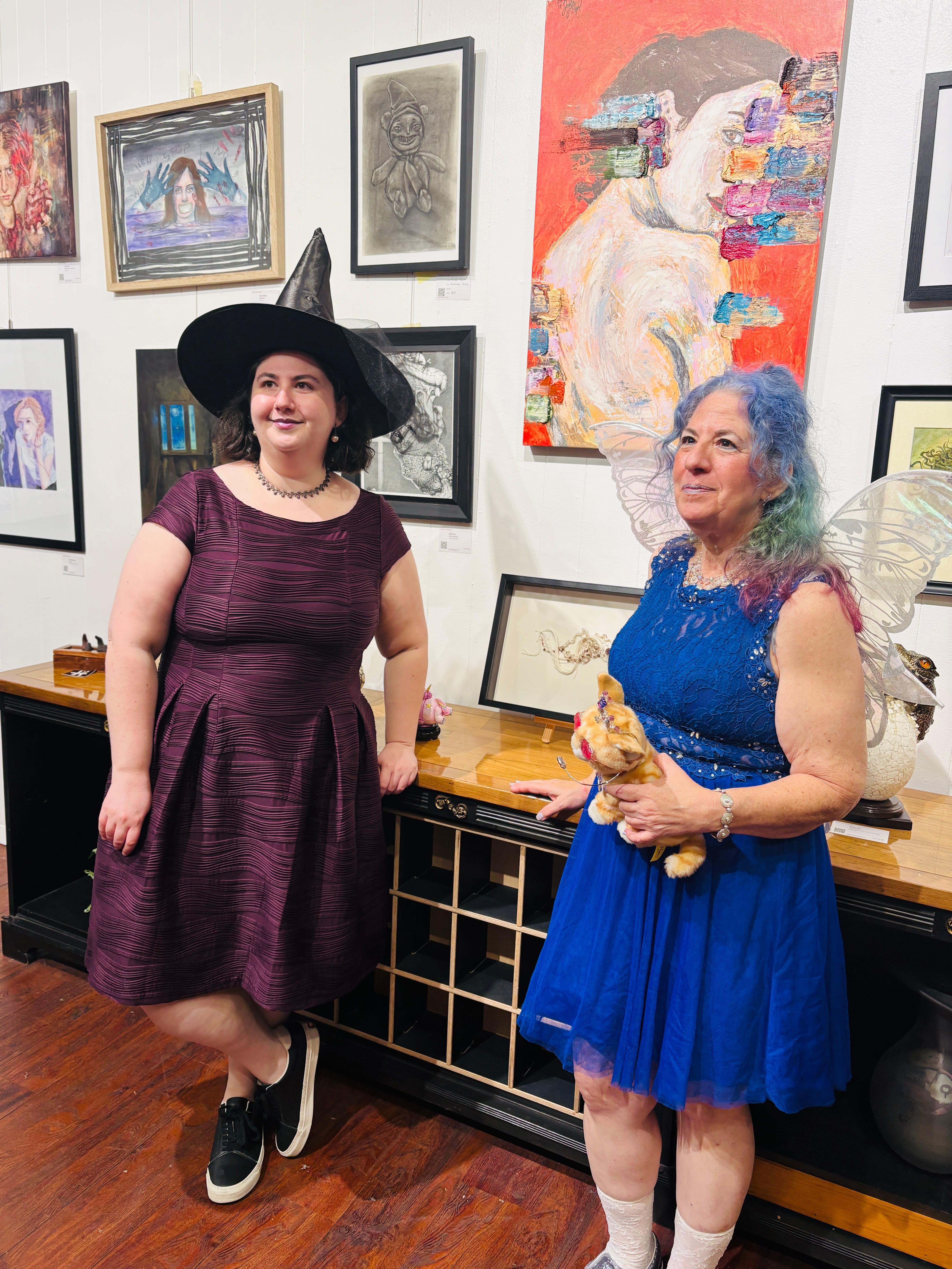 two women in costume at art show