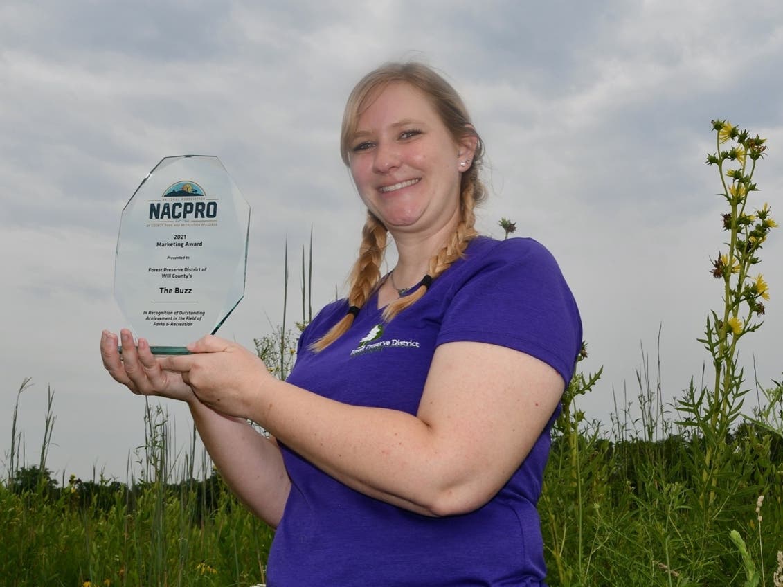 Suzy Lyttle, the forest preserve's program coordinator and the show's host, holds the award. 
