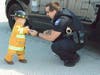 North Aurora Police Officer Kyle Jensen gave a local 4-year-old a junior officer badge from the police department at its inaugural trunk-or-treat event.