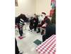 A girl uses American Sign Language to discuss holiday wishes with signing Santa at Aurora Noon Lions Club's 15th annual pizza party for Aurora-area deaf and hearing-impaired kids Thursday.