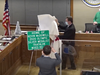 Mayor Kevin Burns and City Council members presented Olympic silver medalist Kevin McDowell with an honorary street sign at Monday night's meeting.