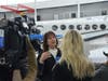 Oswego's Rene Koehler, center, gives press interviews about the Ukraine airlift Tuesday. Koehler accompanied the flight that took off from Aurora Municipal Airport Tuesday morning.