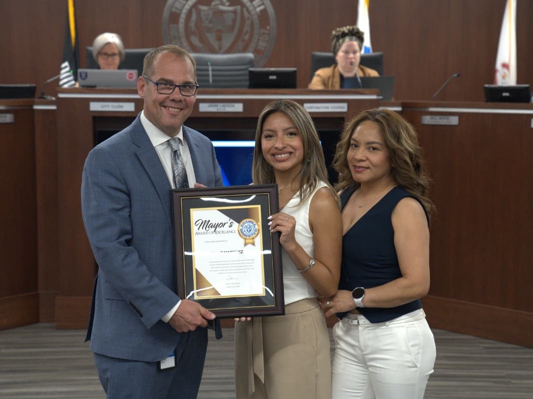 Mayor John Laesch honored Giselle Martinez (center) with the Mayor's Award of Excellence at Tuesday night's Committee of the Whole meeting. The two posed for a photo along with Martinez's mother, Ana.