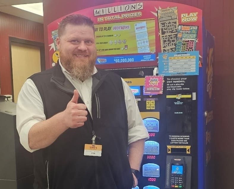 John Moorehouse, the store director at Tony’s Fresh Market in Plainfield, poses for a photo after the store sold a $10.25 million jackpot-winning Lotto ticket.