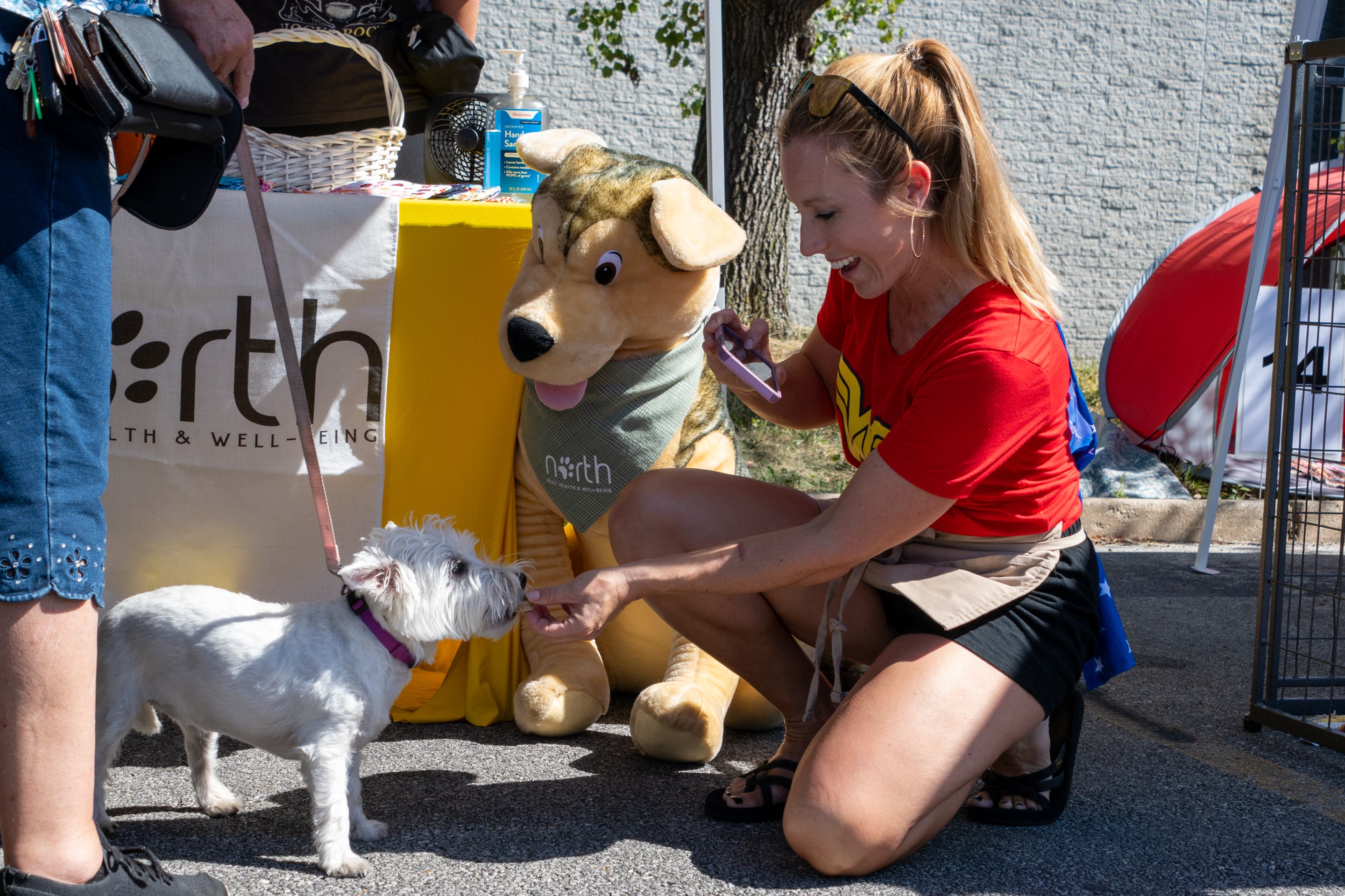 Vendor Christy Rae of North Dog Treats greeting a dog at Pet-Palooza.