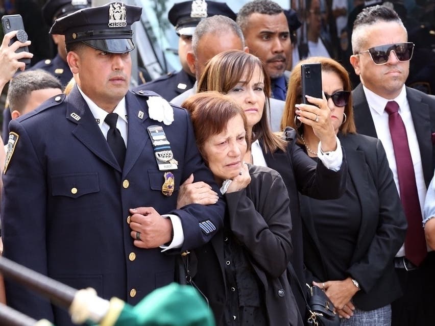 New York City Police Officer Rodney Rubert stands with other members of the Gonzalez/Rubert family Monday during ceremonies for Pentagon Force Protection Agency Officer George Gonzalez.