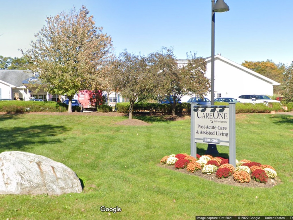 An older patient went missing from CareOne at Parsippany before authorities found him dead outside. His widow is suing the nursing home.