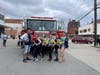 Young performers take a break after their dance performance to check out a Dover Fire Department truck at Connecting Dover's 2021 Cultural Connections Festival.